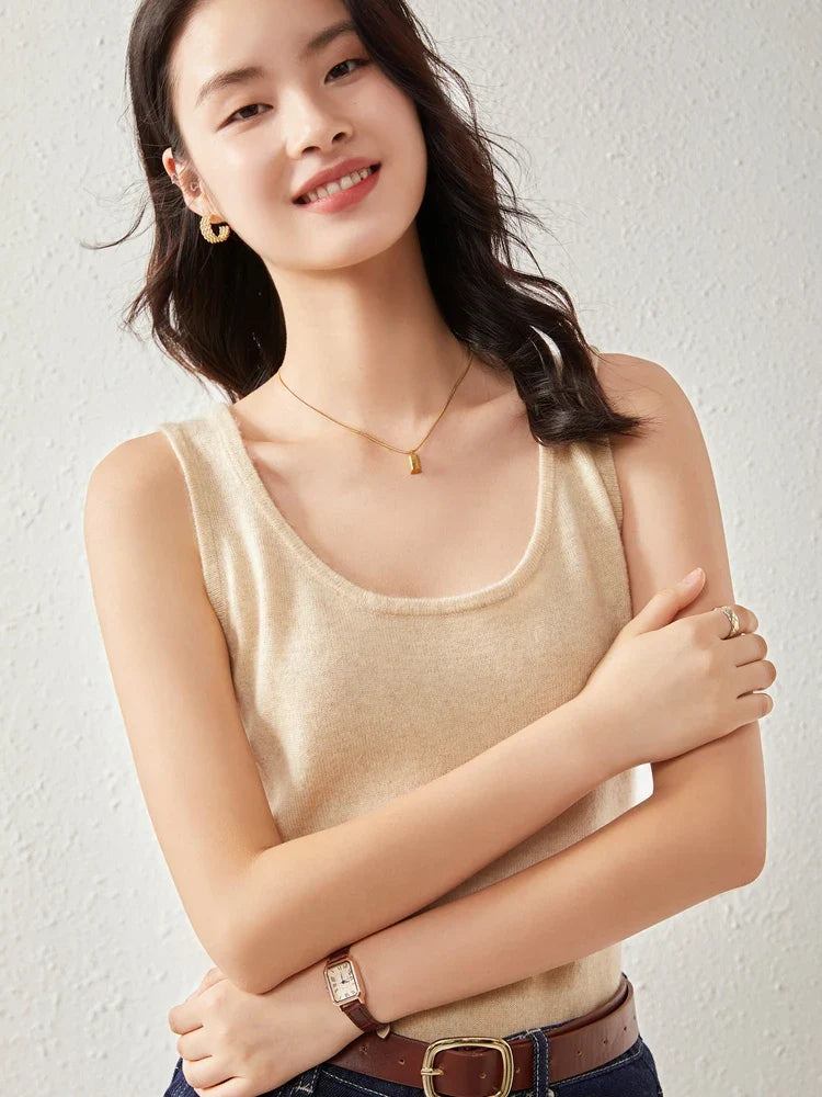 Soft beige FJØRNA women's cashmere top with long sleeves and a relaxed fit, showcased on a neutral background.