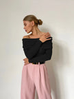 Off-shoulder ribbed knit top for women by FJØRNA, featuring a fitted design and soft fabric in a stylish ribbed pattern.