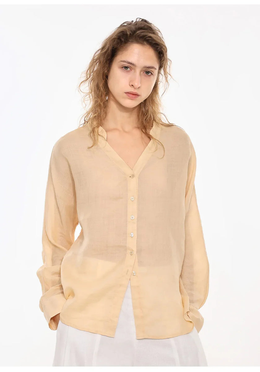 FJØRNA women's linen V-neck shirt displayed on a hanger, lightweight and breathable casual top for warm weather.