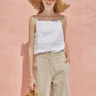 FJØRNA satin-trimmed linen cami top in neutral color, featuring delicate satin details and lightweight, breathable fabric.