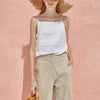 FJØRNA satin-trimmed linen cami top in neutral color, featuring delicate satin details and lightweight, breathable fabric.