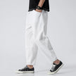 FJØRNA cropped linen trousers in indigo color, featuring a relaxed fit and lightweight fabric, suitable for casual or summer wear.