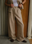 Women’s linen blend wide-leg trousers by FJØRNA with high waist and relaxed fit, shown in a neutral color.