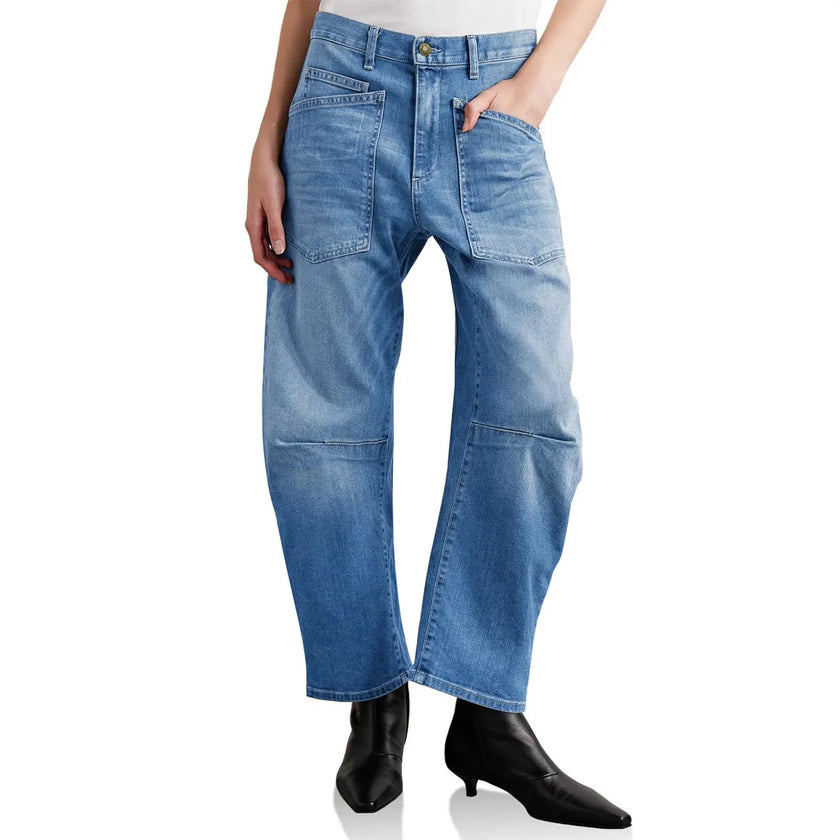 FJØRNA women's denim jeans with a barrel leg fit, showcasing classic blue wash and stylish tapered leg design.