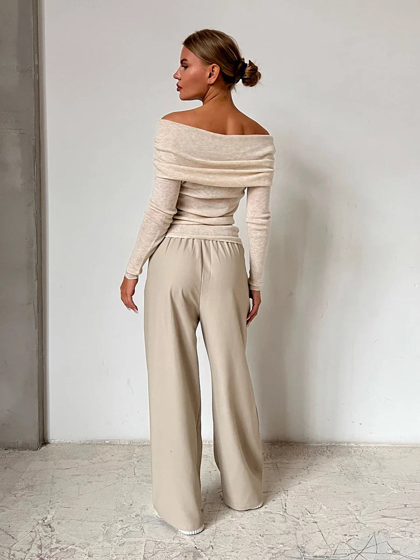 FJØRNA women's ribbed knit off-shoulder top with long sleeves, close-up view showing the textured fabric and stylish fit.