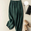 FJØRNA women's linen wide-leg trousers with elastic waist, stylish and comfortable pants for women, shown in natural fabric and relaxed fit.