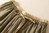 FJØRNA women's linen tapered trousers with a relaxed fit, lightweight fabric, and classic design for casual and stylish wear.
