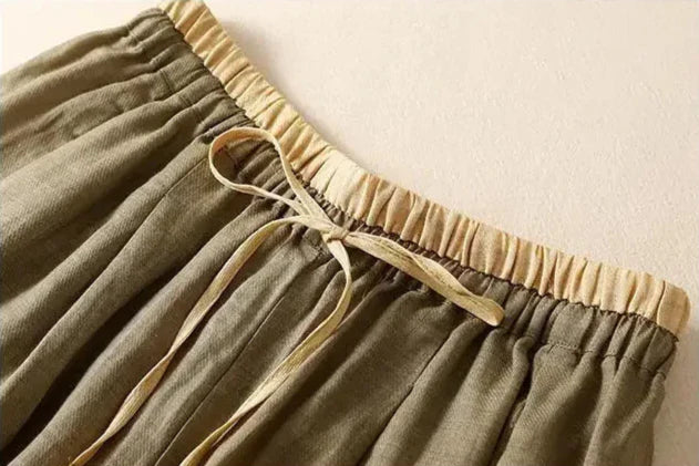 FJØRNA women's linen tapered trousers with a relaxed fit, lightweight fabric, and classic design for casual and stylish wear.