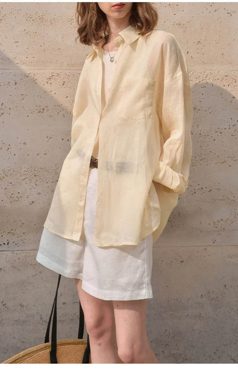 Light beige linen shirt for women by FJØRNA, featuring a relaxed fit and classic collar, styled on a model.