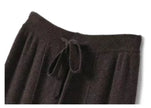 FJØRNA women's merino wool wide leg high waist trousers, demonstrating soft, cozy fabric and stylish fit.