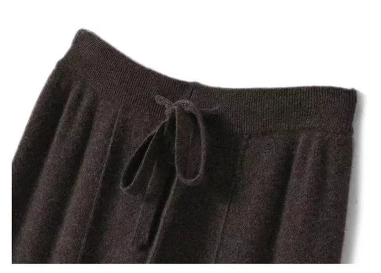 FJØRNA women's merino wool wide leg high waist trousers, demonstrating soft, cozy fabric and stylish fit.