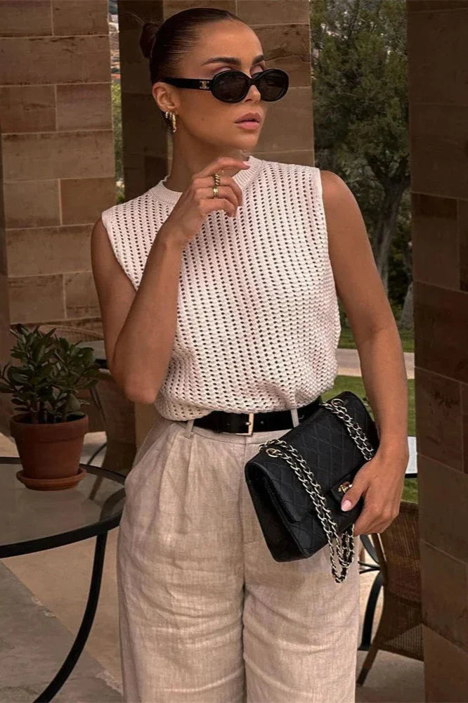 FJØRNA women's sleeveless knit tank top, soft and fitted, shown on a model with a casual, stylish look.