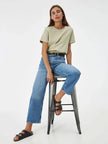 Women’s cotton T-shirt from FJØRNA, casual top with short sleeves and a classic fit, shown in a neutral color.