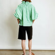 FJØRNA women's cotton blouse with ruffle detail, featuring a stylish and breathable top for casual or dressy occasions.