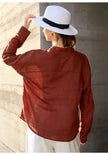 Women’s linen V-neck shirt by FJØRNA, lightweight and breathable top with a relaxed fit, shown in natural fabric texture.