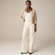 FJØRNA women's wide-leg cotton jeans with high waist, showcasing relaxed fit and stylish design in a natural pose.