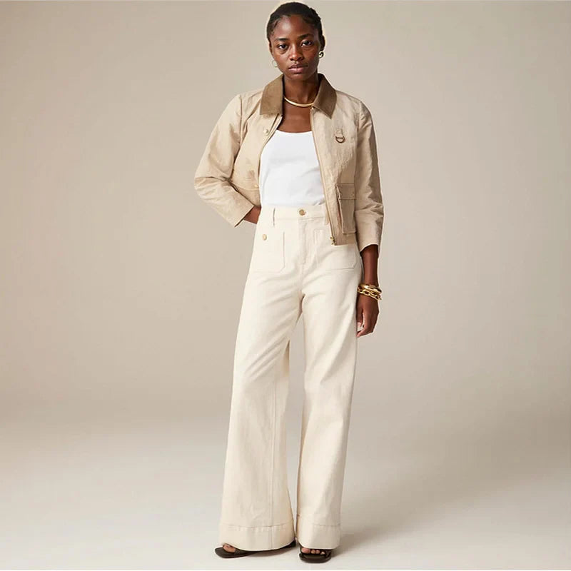 FJØRNA women's wide-leg cotton jeans with high waist, showcasing relaxed fit and stylish design in a natural pose.