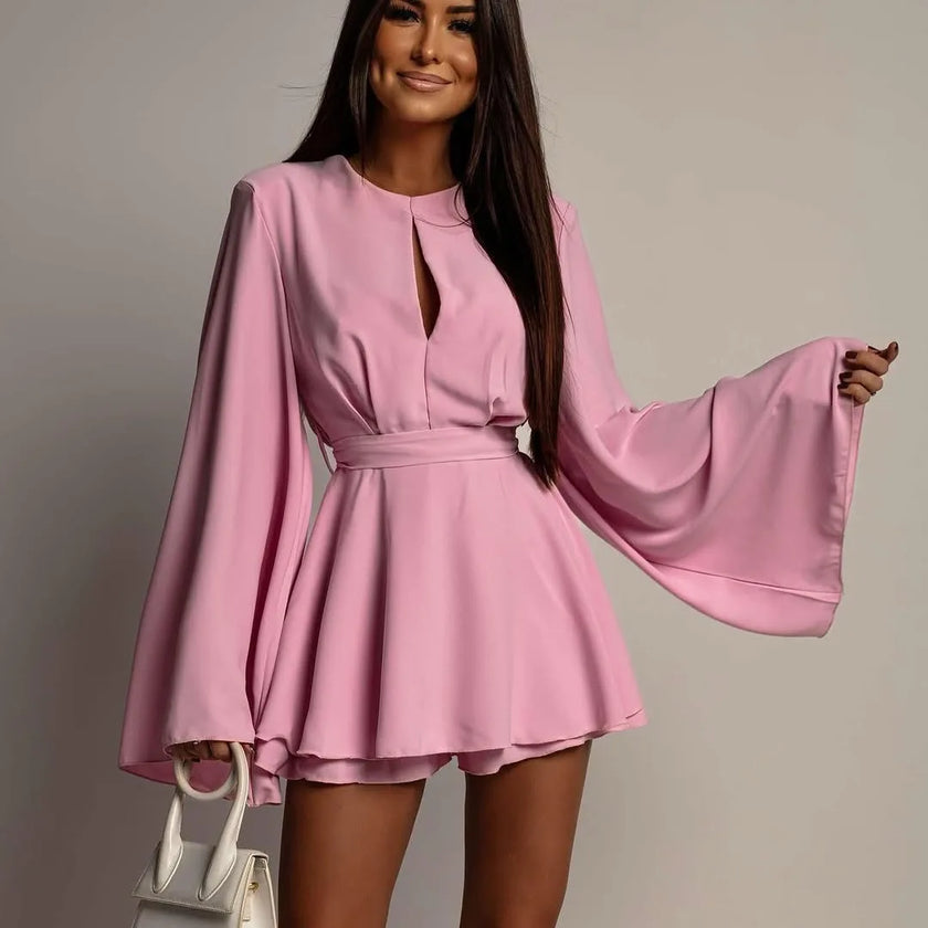 FJØRNA white mini dress shown on a model, sleeveless design with a fitted silhouette, perfect for casual and summer occasions.