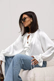 FJØRNA satin blouse for women featuring elegant ruffle details and a stylish top design, perfect for sophisticated outfits.