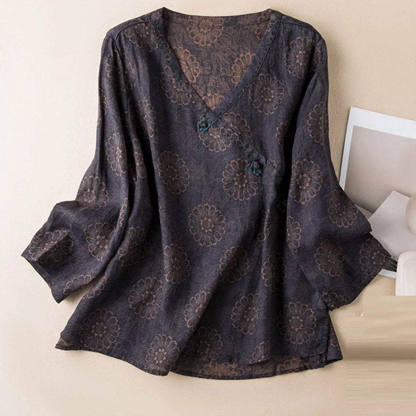 FJØRNA Kaien wrap-style blouse featuring long sleeves, V-neck, and a fitted waist in soft fabric.