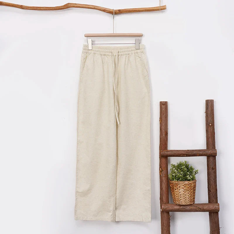 Women’s wide leg cotton linen trousers with drawstring pull-on design by FJØRNA, shown in a relaxed fit style.