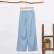 Women’s cotton linen wide-leg trousers by FJØRNA featuring a drawstring pull-on design and relaxed fit.