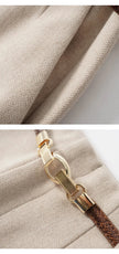 Women's wool wide leg trousers by FJØRNA featuring high waist and tailored fit, shown in neutral fabric with a relaxed silhouette.