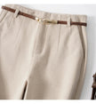 Women’s wide-leg wool trousers by FJØRNA with high waist and tailored fit, shown in a natural fabric and stylish cut.