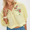 Women's embroidered crop top by FJØRNA, featuring detailed embroidery and a trendy, fitted design.