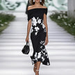 FJØRNA fitted off-shoulder mermaid midi dress with draped neckline and floral pattern, showcasing elegant evening wear style.