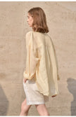 Light beige linen shirt for women by FJØRNA, featuring a relaxed fit and classic collar, displayed on a neutral background.