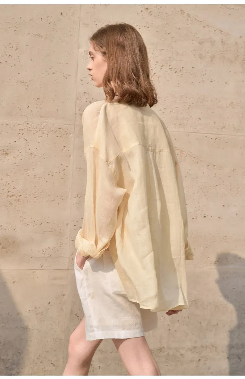 Light beige linen shirt for women by FJØRNA, featuring a relaxed fit and classic collar, displayed on a neutral background.
