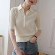 FJØRNA ribbed knit polo blouse for women, showing a close-up of the textured fabric and classic polo collar.
