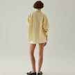 FJØRNA linen shirt with slit hem detail, featuring a relaxed fit and lightweight fabric, ideal for casual or stylish wear.