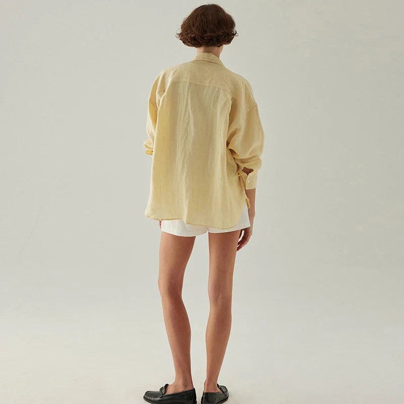 FJØRNA linen shirt with slit hem detail, featuring a relaxed fit and lightweight fabric, ideal for casual or stylish wear.