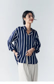 Lacceti Maren Stripe Satin Blouse featuring a stylish striped pattern and silky fabric, displayed on a hanger.