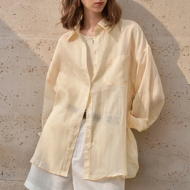 Light beige linen shirt for women by FJØRNA, featuring a relaxed fit and breathable fabric, perfect for casual wear