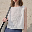 FJØRNA women's sleeveless linen crop top showing lightweight, breathable fabric and stylish design on a neutral background.