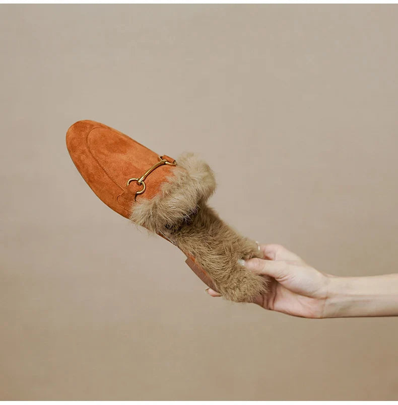 FJØRNA women's plush-lined fur mule slippers with slip-on design and luxurious comfort, shown in cozy indoor setting.