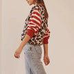 FJØRNA women's cotton cardigan, soft and lightweight tops, shown in a natural pose with buttons and long sleeves.