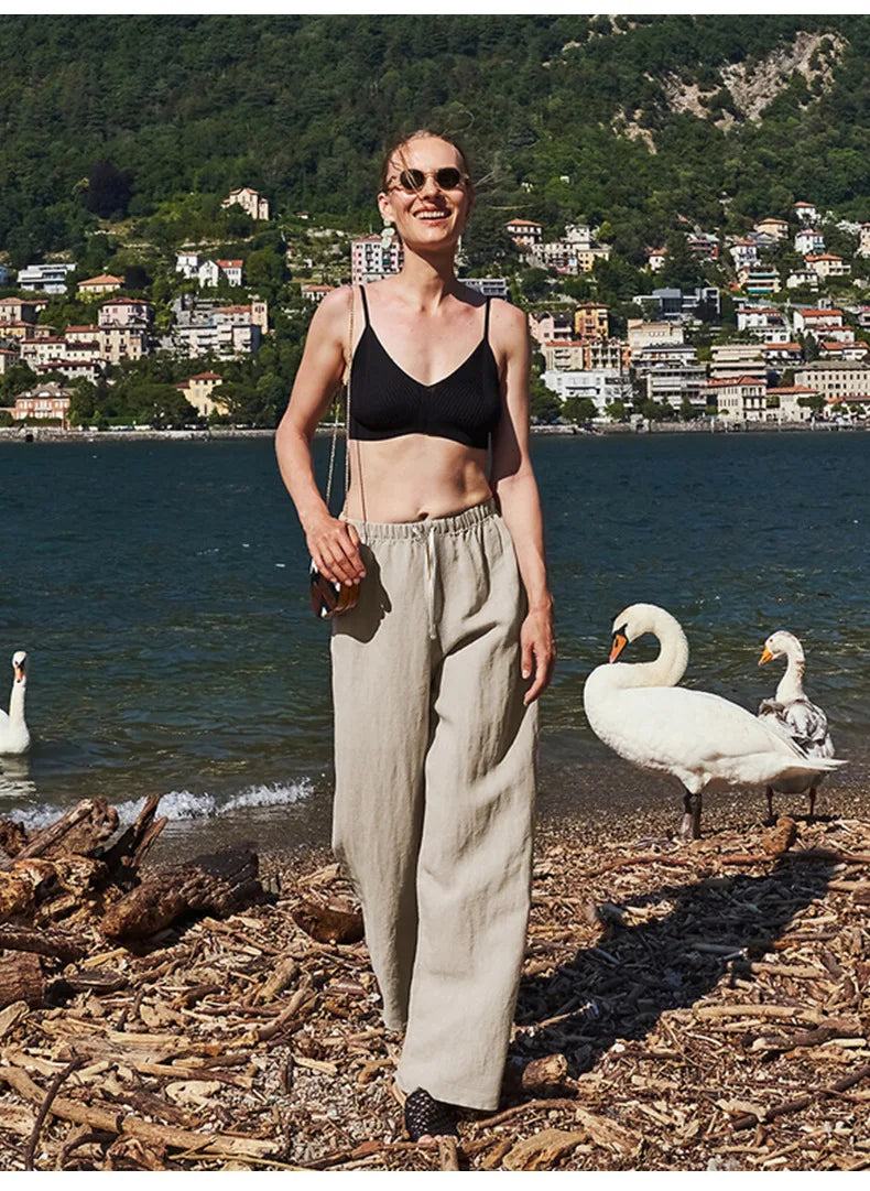 FJØRNA women's knit top, soft and cozy, with a fitted style and ribbed details, shown in a neutral color on a model.