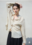 Light beige linen shirt for women by FJØRNA, featuring a relaxed fit and button-up front, perfect for casual or summer wear.