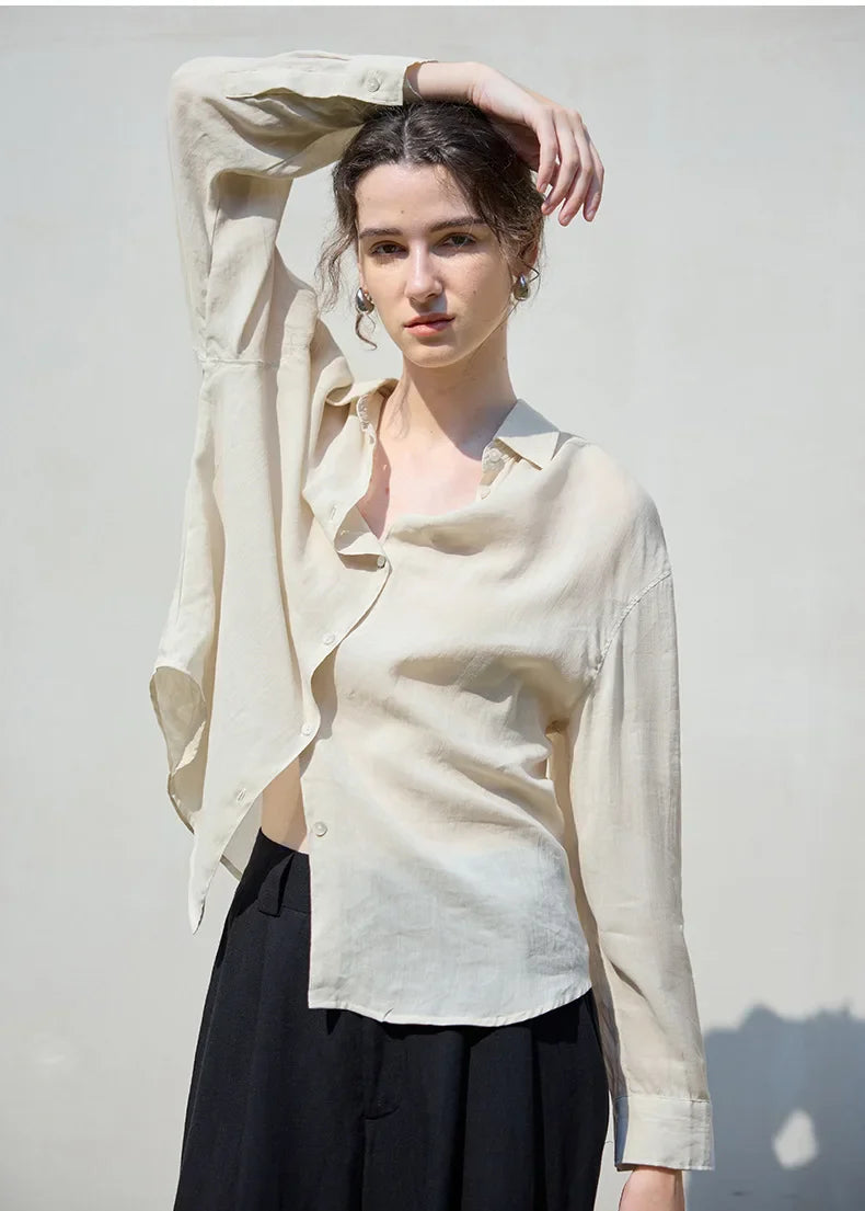 Light beige linen shirt for women by FJØRNA, featuring a relaxed fit and button-up front, perfect for casual or summer wear.