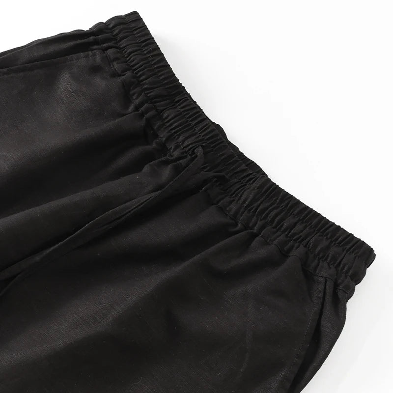 Women's cotton linen wide-leg trousers by FJØRNA with drawstring pull-on design, shown in a comfortable, relaxed fit.