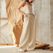 FJØRNA square neck linen cropped tank top displayed on a hanger, showcasing its lightweight fabric and stylish design.