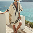 FJØRNA floral summer beach cover-up for women, flowy and lightweight with vibrant floral patterns, perfect for seaside wear.