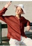 Light beige linen women's V-neck shirt by FJØRNA, showing the relaxed fit and soft fabric texture.