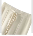FJØRNA women's merino wool wide-leg high-waist trousers featuring a relaxed fit and elegant design.