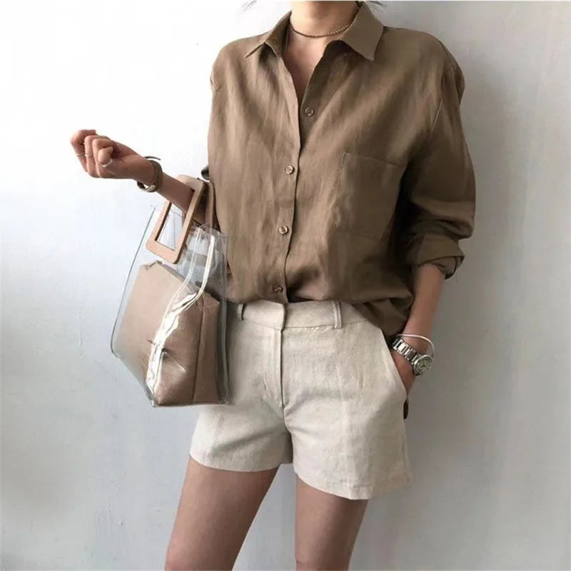 FJØRNA women's linen shirt with open collar, lightweight and breathable top, showcased on a model.