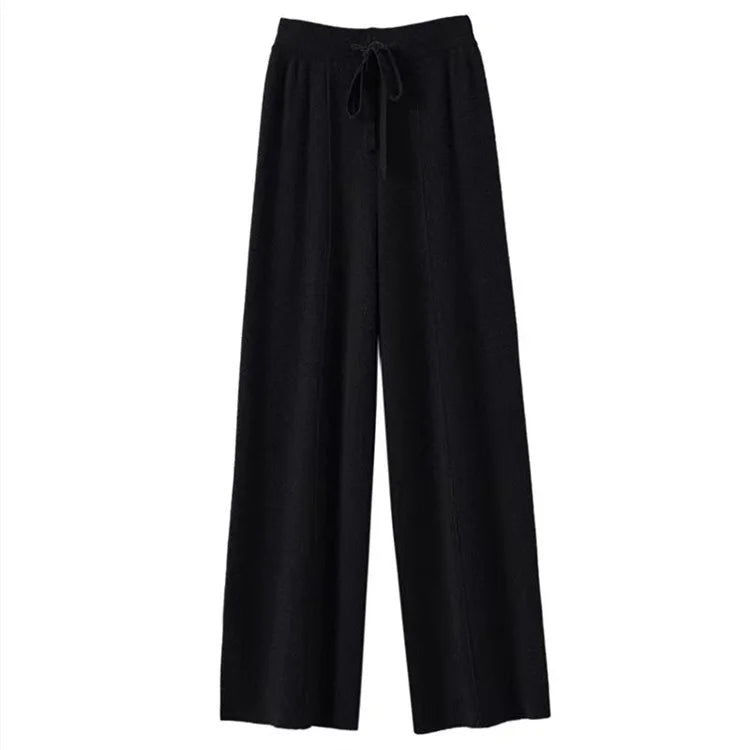 FJØRNA women's merino wool wide-leg high-waist trousers, featuring a smooth fit and classic design, shown on a model.